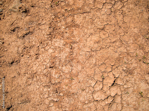 Dry cracked soil texture and background. Red soil background. Abstract ground. Natural abstraction. Cracked soil background. Clay. Ocher