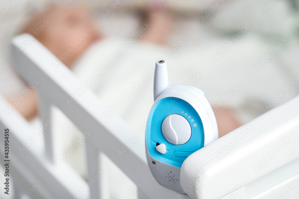 Modern baby monitor on bed, closeup Modern baby monitor on bed, closeup