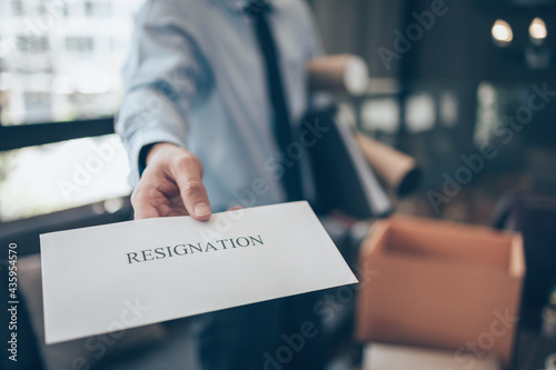 Businessman sending and showing resignation letter to employer boss. Quiting a job, businessman fired or leave a job concpet. photo