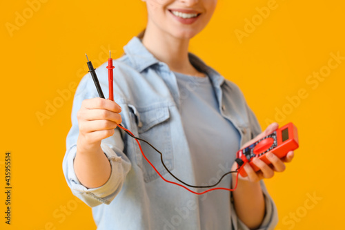 Young female electrician wi...