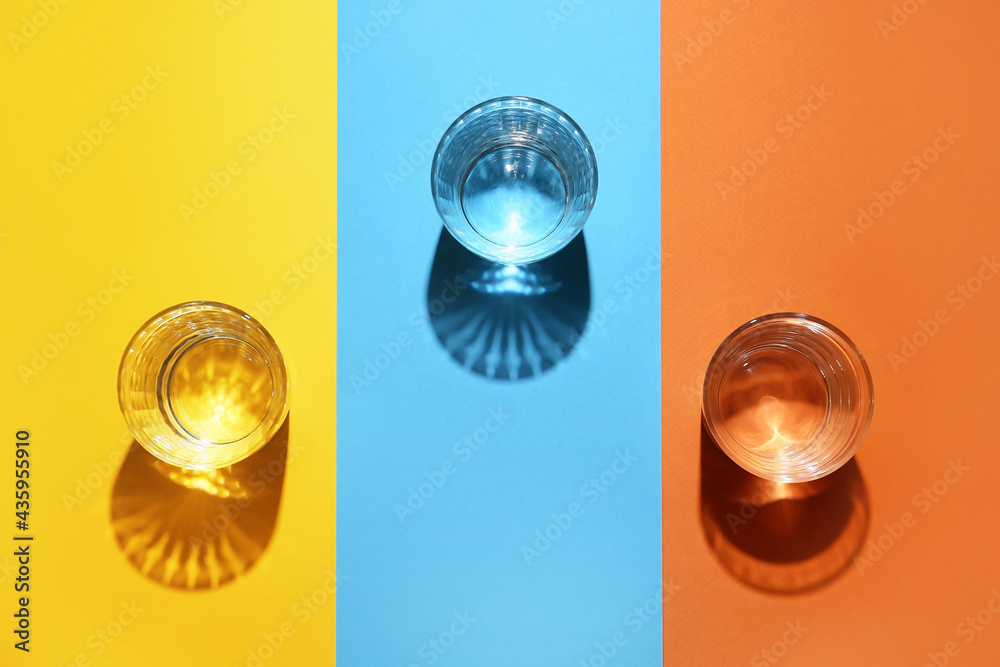 Glasses of water on color background Glasses of water on color background