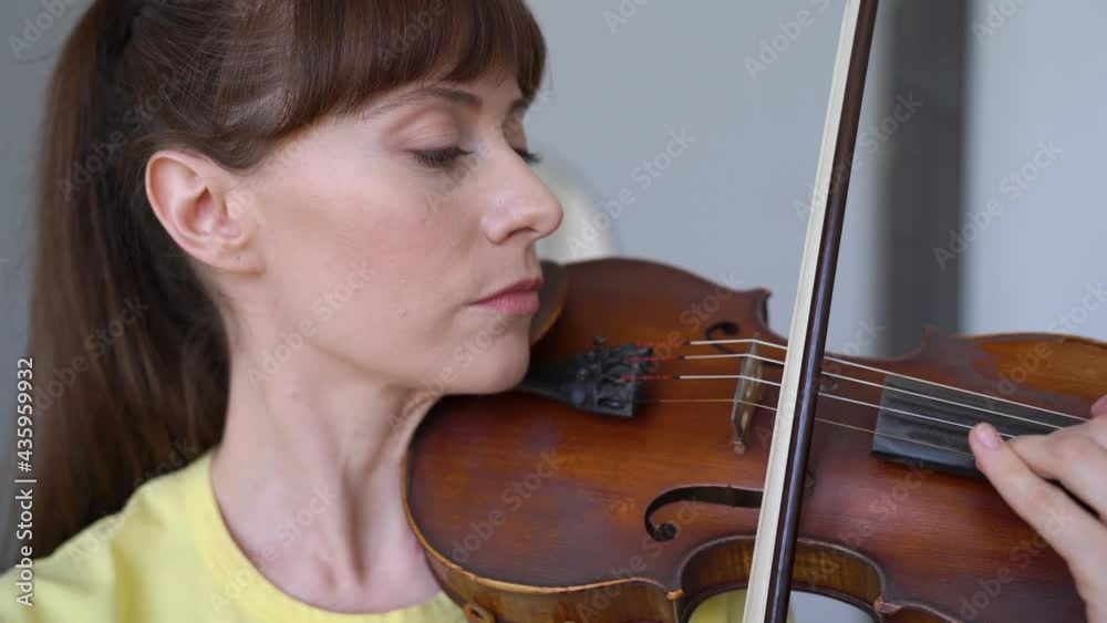 Portrait Of Young Woman Having Fun Practicing Playing The Violin, Close-up Shot Portrait Of Young Woman Having Fun Practicing Playing The Violin, Close-up Shot