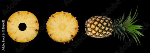 Pineapple set. Whole pineapple and slices isolated on black background. Picture of tropical fruit