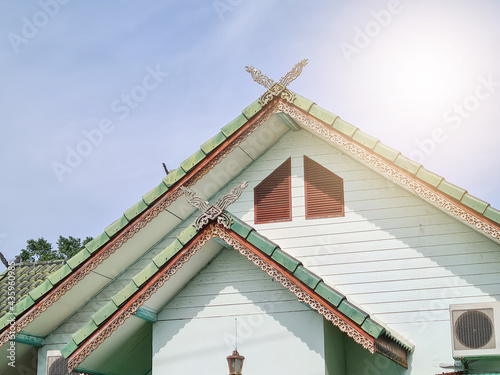 Large triangular gable roof with Thai pattern And green tiles © squallice