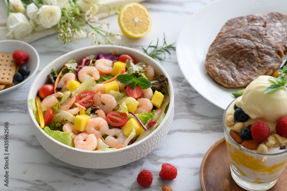 Steaks, salads, desserts and other delicacies on the table