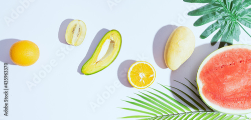 Fototapeta Naklejka Na Ścianę i Meble -  Tropical fruits like mango, orange, watermelon, avocado are arranged on a white background