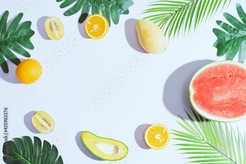 Fototapeta Naklejka Na Ścianę i Meble -  Tropical fruits like mango, orange, watermelon, avocado are arranged on a white background