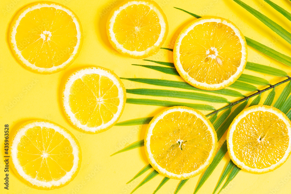 Orange slices placed on a yellow background