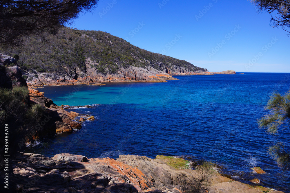 Beautiful scenery on the east coast of Tasmania, with red rocks and turquoise water, Australia