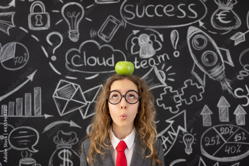 Young businesswoman against chalkboard with business sketch Young businesswoman against chalkboard with business sketch