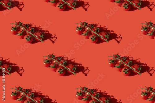 Sprig cherry tomato pattern on red background