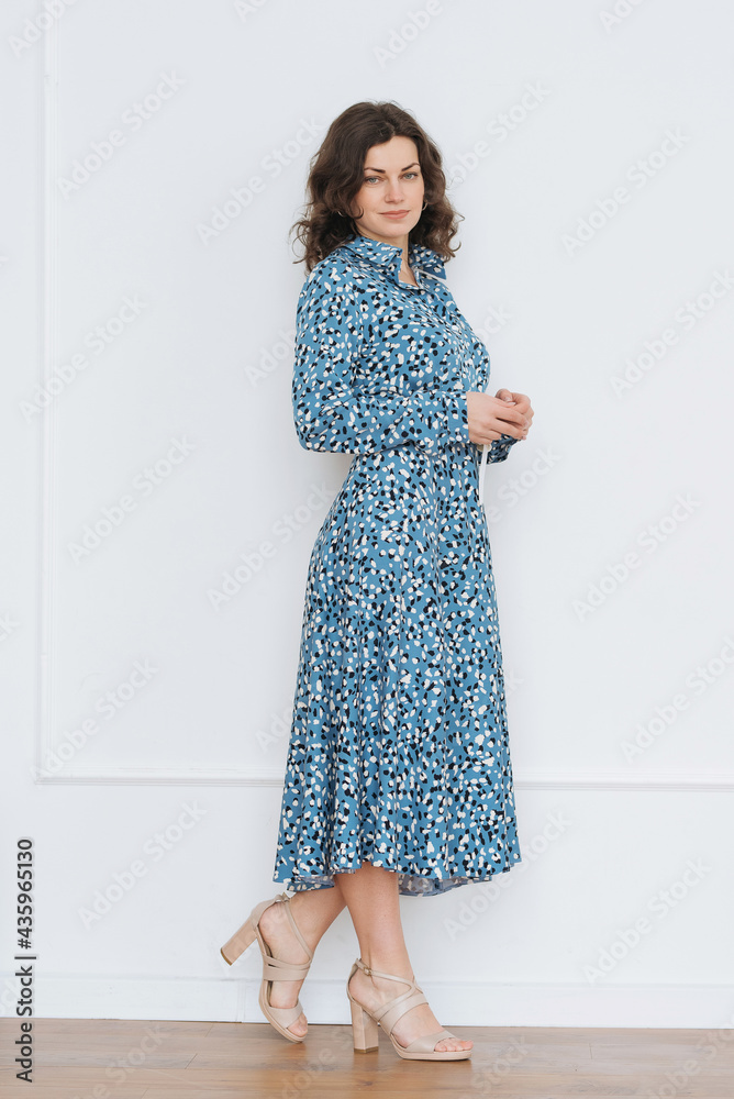 Portrait of pretty young caucasian woman with light natural make up on the background of white wall at home Portrait of pretty young caucasian woman with light natural make up on the background of white wall at home