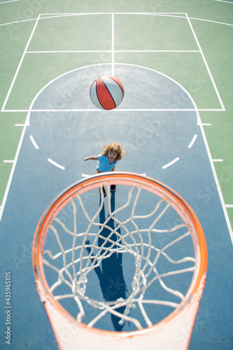 Top view of Child playing basketball. Healthy children lifestyle. Kids sport activity.