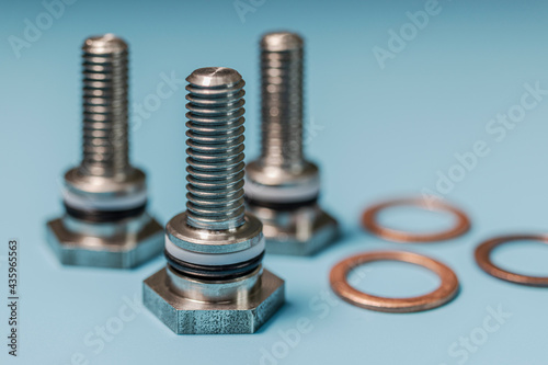 Metal bolts with copper nuts. Close-up. Macro shooting. Copy space.