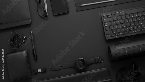 Business concept. Flat lay composition with various black gadgets on dark black surface