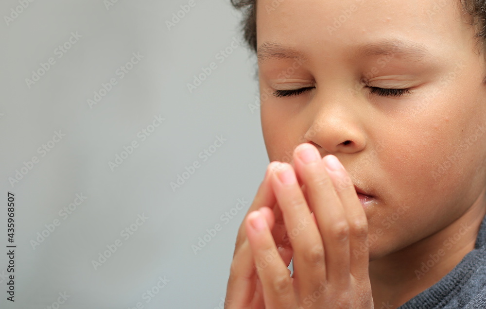 boy praying to God with hands together on white background stock photo boy praying to God with hands together on white background stock photo