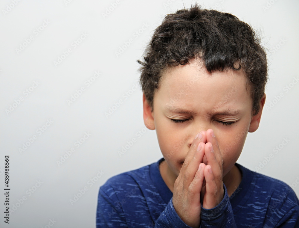 boy praying to God with hands together on white background stock photo boy praying to God with hands together on white background stock photo