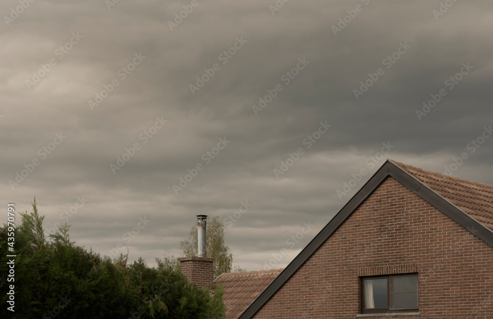 Roofs of houses in bad weather. Cloudy sky before the rain
