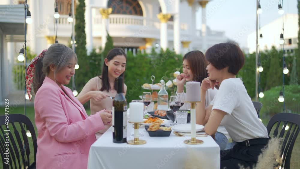 Happy Asian woman friends have dinner party in the garden together at night. Female friendship enjoy and having fun celebration party nightlife with eating food, drinking wine and talking together. Happy Asian woman friends have dinner party in the garden together at night. Female friendship enjoy and having fun celebration party nightlife with eating food, drinking wine and talking together.