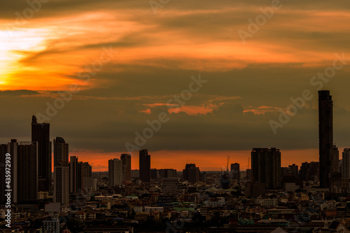 The high angle background of the city view with the secret light of the evening, blurring of night lights, showing the distribution of condominiums, dense homes in the capital community