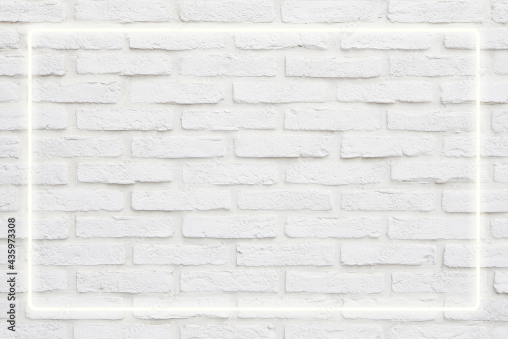 Fototapeta premium Background texture of empty white retro brick wall with neon light lamp frame
