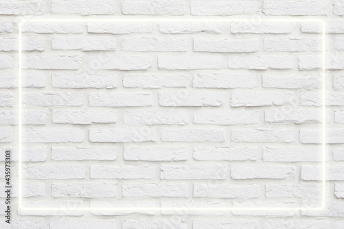 Background texture of empty white retro brick wall with neon light lamp frame