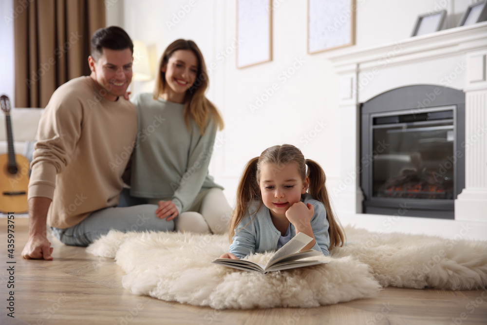 Happy family resting near fireplace at home Happy family resting near fireplace at home