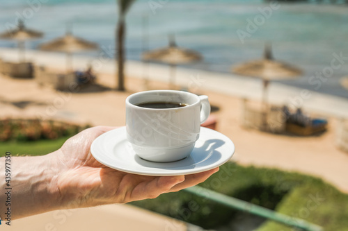 Man hands holding cup of coffee. Good morning sunrise concept. Lets start a new day. Space for text
