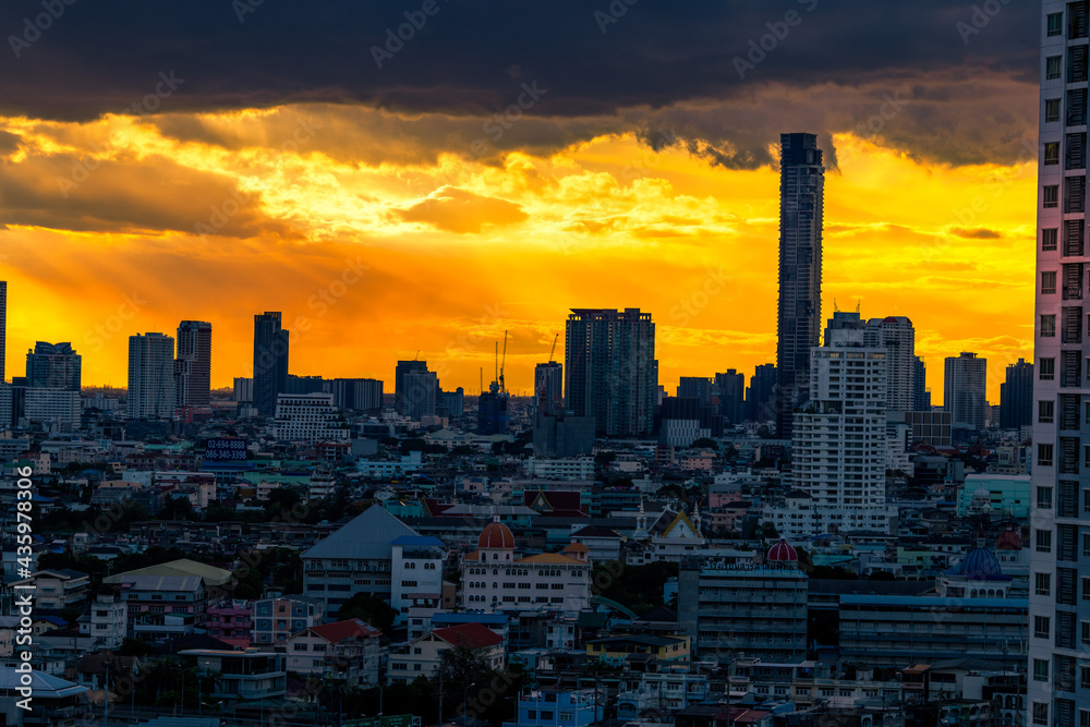 The high angle background of the city view with the secret light of the evening, blurring of night lights, showing the distribution of condominiums, dense homes in the capital community