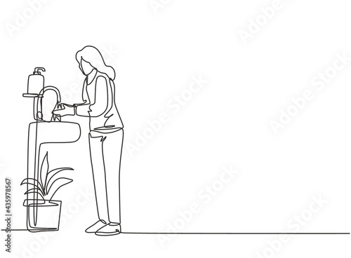 Continuous one line drawing a woman washes her hands in the sink, there is a soap dish by the tap and there is a pot of plants under the sink. Single line draw design vector graphic illustration.