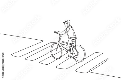 Single one line drawing of a young man riding a bicycle crossing the zebra crossing at a crossroads.