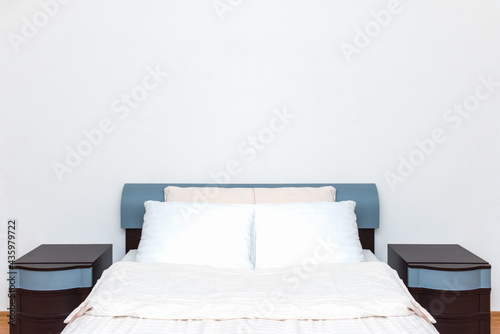 Beautiful clean and modern bedroom with a blank wall to add text, logo, image, etc.