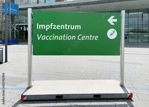 bilingual vaccination center sign in German and English photo
