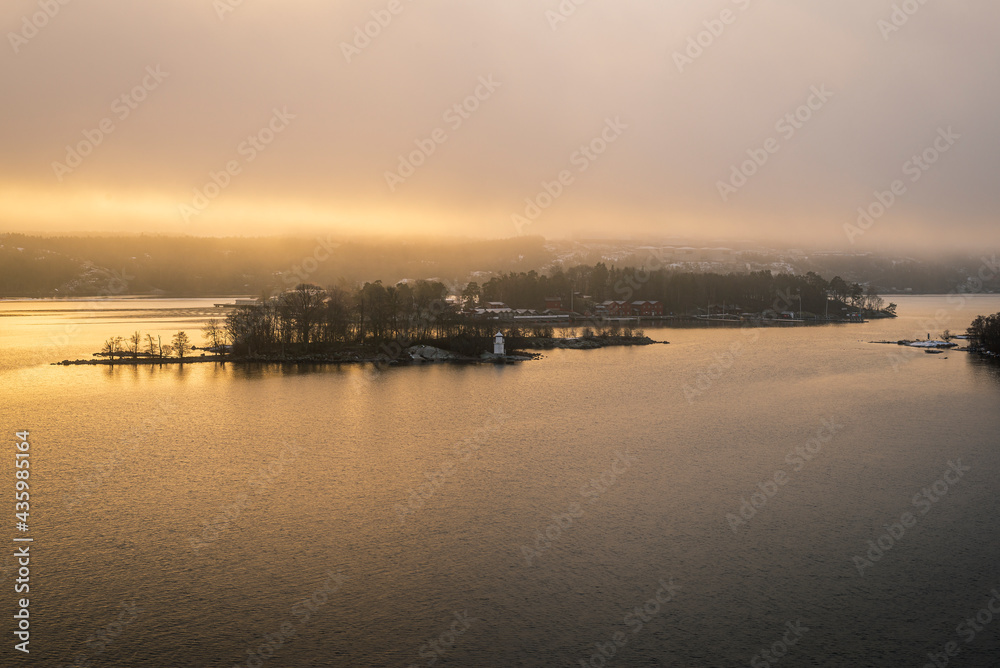 Small islets in Stockholm fjords on a misty winter morning