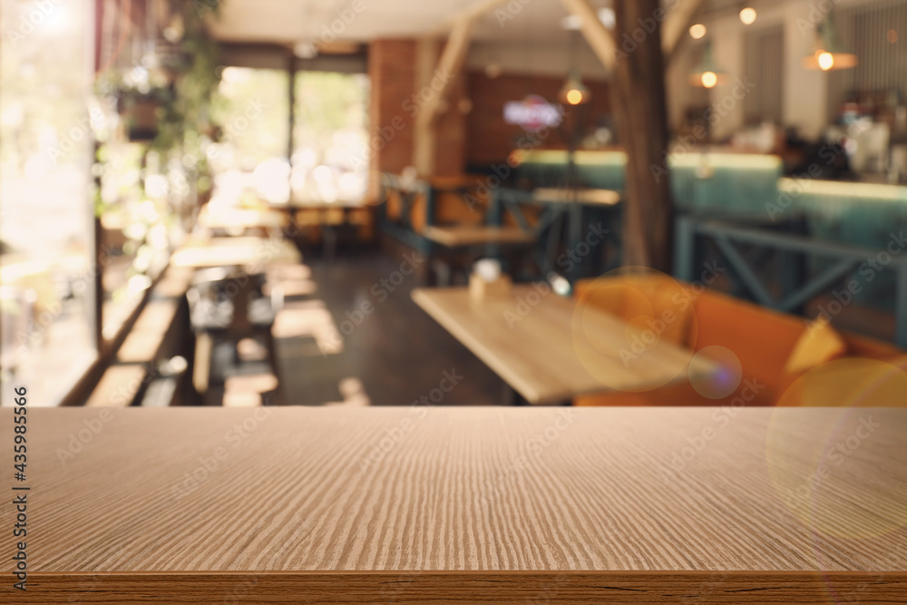 Empty wooden table in cafe. Bokeh effect Empty wooden table in cafe. Bokeh effect