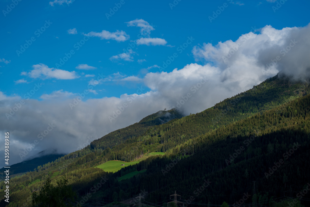 beautiful wide view in the mountains on a sunny spring day with clouds