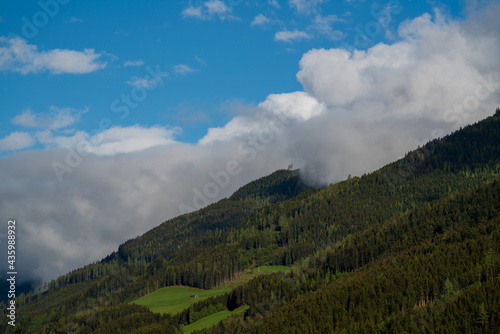 beautiful wide view in the mountains on a sunny spring day with clouds