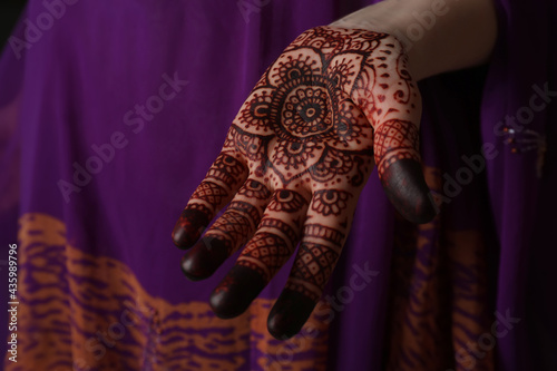 Woman with henna tattoo on palm, closeup. Traditional mehndi ornament © New Africa