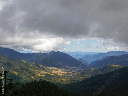 Beautiful landscape view on valley and mountains under heavy clouds from Thrumshingla pass, Mongar district, Bhutan