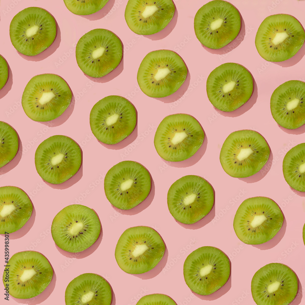 Fototapeta premium fresh green fruit on a pink background.trendy pattern summer concept