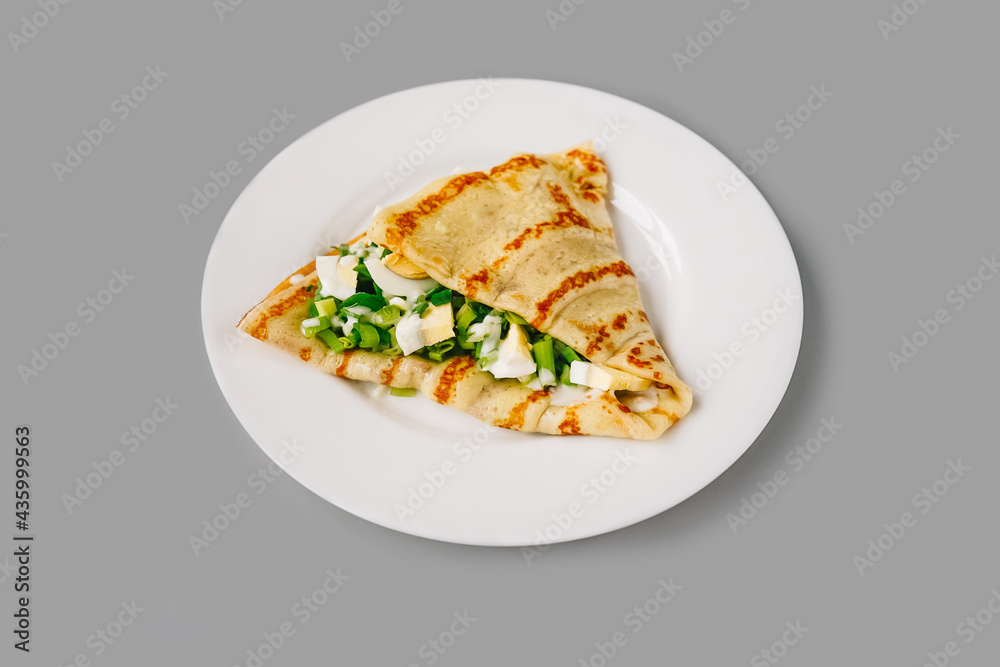 Person eating crepes with filling. Tasty breakfast. Person eating crepes with filling. Tasty breakfast.