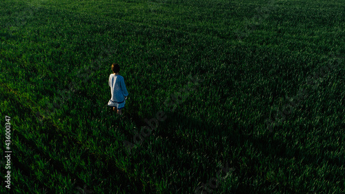 Fototapeta Naklejka Na Ścianę i Meble -  Young happy woman in green field. Concept of success hope dream way and ambition