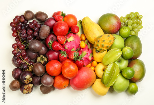 Assortment of fresh exotic fruits on white background  flat lay