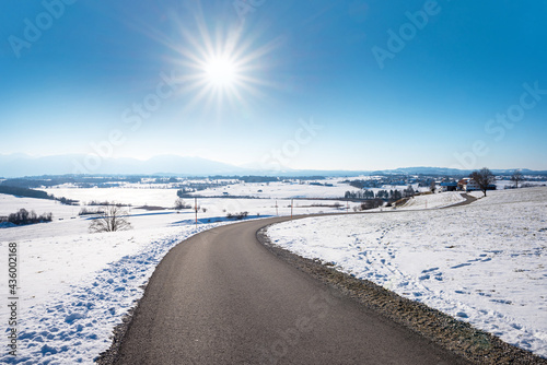curvy walkway near Riegsee, winter landscape upper bavaria with mountain view