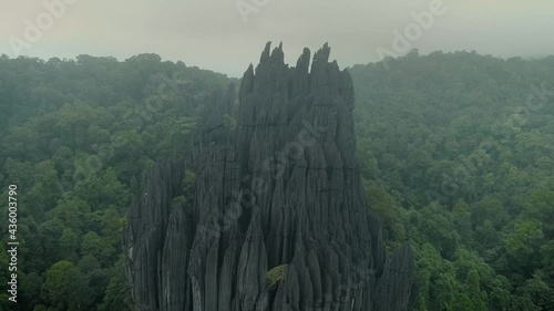 Huge rock monolith on the forests of Yana village, in Karnataka, India, under fog. Drone aerial view photo