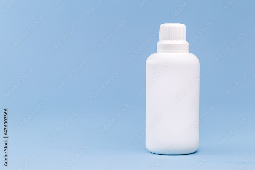Plastic bottle for hydrogen peroxide, blue background, medicine concept, with copy space Plastic bottle for hydrogen peroxide, blue background, medicine concept, with copy space