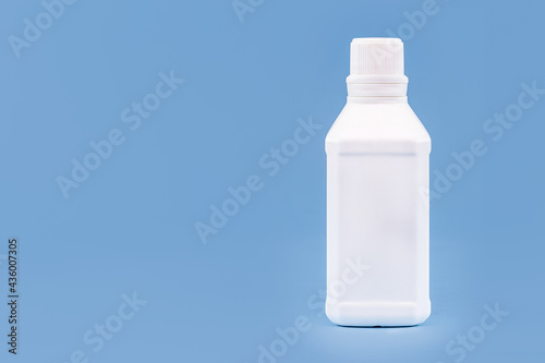 Plastic bottle for hydrogen peroxide, blue background, medicine concept, with copy space