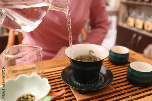 Master conducting traditional tea ceremony at table, closeup