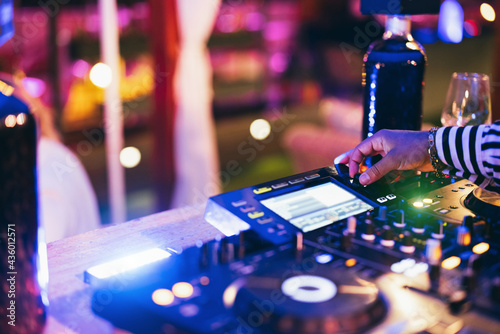 Photography Black Dj playing music at cocktail bar outdoor while - Focus on right hand