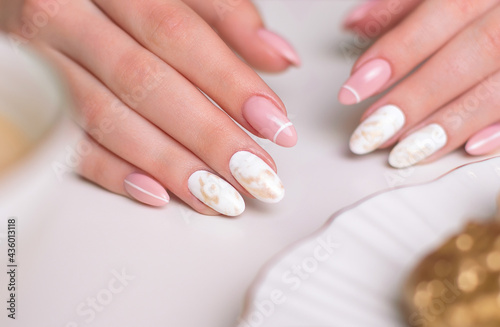 Beautiful female hands with luxury manicure nails  pink and white gel polish